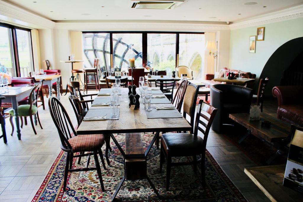 Restaurant dining room with the waterwheel visible through the arched windows