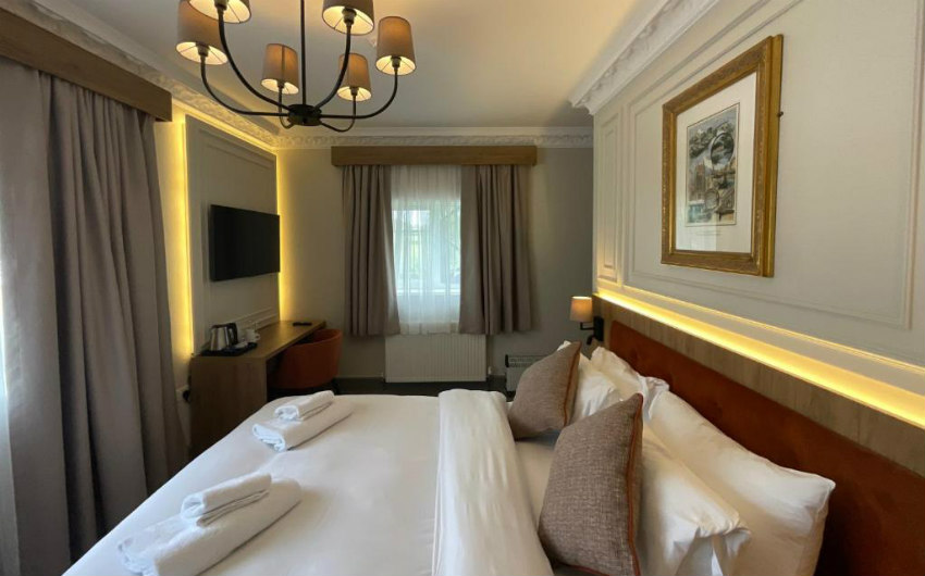 Classic Double bedroom with framed print and warm lighting