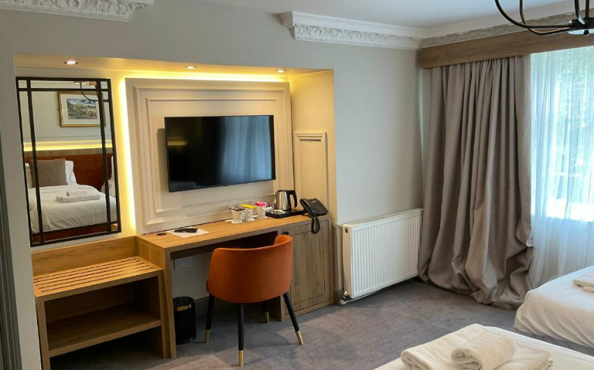 Superior Double interior with panelled walls, a writing desk, and warm linen lighting